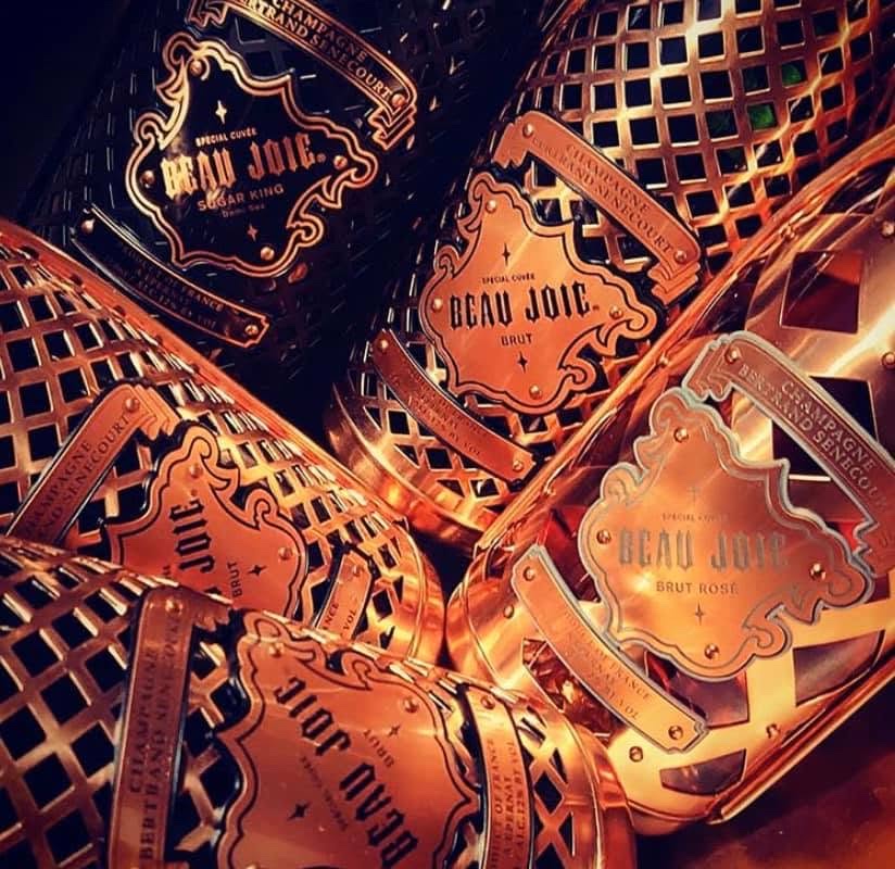 Beau Joie champagne bottles in their copper-clad cages.